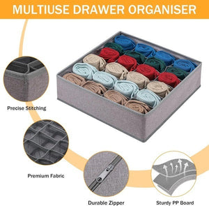 A gray multi-use drawer organizer with numerous compartments neatly contains rolled socks in various colors. Inset circles highlight features such as precise stitching, premium fabric, a durable zipper, and a sturdy PP board construction. Text at the top reads MULTIUSE DRAWER ORGANISER.drawer organiser, clothes organiser, sock organiser, multiuse organiser, wardrobe organiser, household items, home essentials, home improvement store, home improvement, storage solutions.