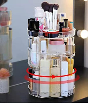 A clear, rotating cosmetic organizer is shown filled with various makeup brushes, lipsticks, nail polishes, and skincare bottles. Red arrows indicate its 360-degree rotating functionality. The organizer sits on a dark surface, likely a vanity table. Rotating makeup organizer, cosmetic storage, 360 degree organizer, makeup display, skincare storage.