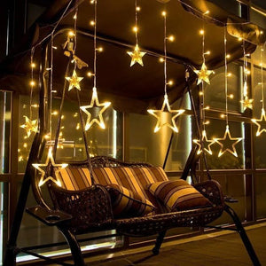 Star-shaped curtain light with 5 small stars and 5 big stars hanging against a window, illustrating its use as a window curtain decoration.