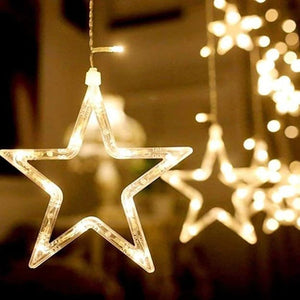 Close-up of the star-shaped curtain light showing the detail of the small and big star designs and the warm glow of the LEDs.