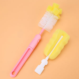 Two baby bottle brushes: one bristle with a pink handle, one sponge with a white/pink handle.bottle brush, baby, cleaning, nursery.