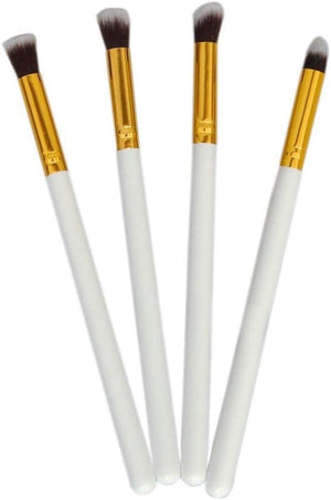 Four white/gold makeup brushes. makeup brushes, cosmetic tools.
