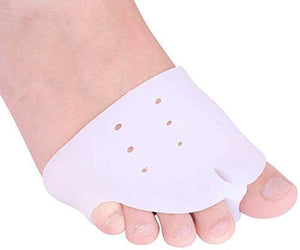 A close-up shows One bare feet,  wearing a white silicone gel toe separator that fits between the big toe and the second toe.toe separators, toe spacer, bunion corrector, hallux valgus, foot care, orthopedic, health and personal care, silicone gel.