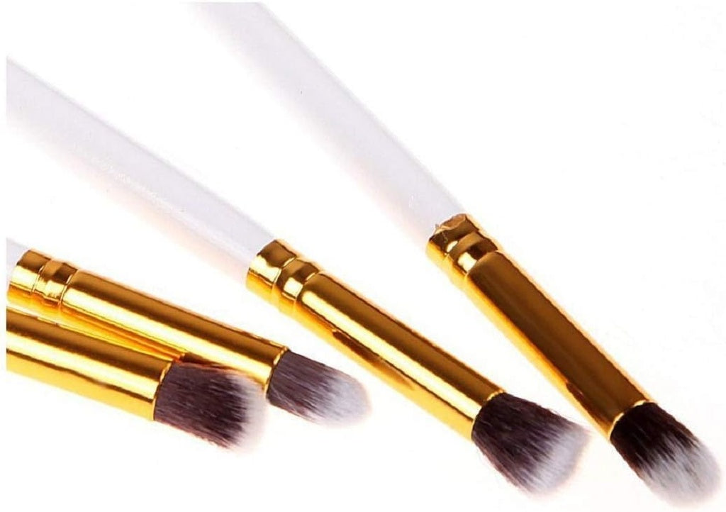 Four white/gold makeup brushes.makeup brushes, cosmetic tools.
