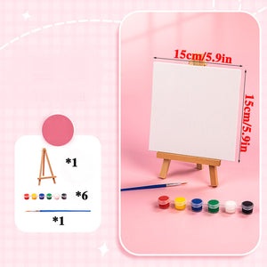 Discover the joy of mini canvas painting with this delightful arts & crafts set. It includes a small easel, 15 cm (5.9 in) canvas, six paint pots in vibrant colors, and a paintbrush. Perfectly presented on a pink backdrop, its an ideal acrylic paint kit for creative exploration.