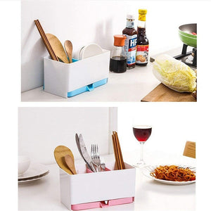 The image shows two different setups featuring a white plastic kitchen utensil holder with three compartments and a drainage system. The top panel shows the holder with wooden spoons and chopsticks, placed near a sink with water draining from it. The bottom panel shows the same holder with a wooden spoon, forks, knives, and chopsticks, placed on a dining table near a plate of noodles and a glass of red wine. utensil holder, kitchen organiser, cutlery drainer, spoon holder, chopsticks holder, knife holder, k