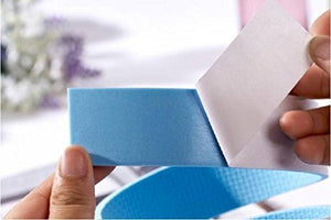 A hand peels back the white adhesive backing from a roll of light blue protective tape.protective tape, adhesive, peeling.