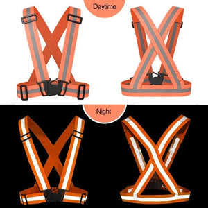 The image is split into two sections, Daytime and Night. The Daytime section shows two views of an orange high-visibility reflective vest belt jacket with grey reflective stripes. The Night section shows the same vest illuminated in the dark, with the reflective stripes appearing bright white. Fell-Track Visibility Protective Safety Reflective Vest Belt Jacket Night Cycling Reflector Safety J, high visibility vest, reflective jacket, safety wear, night safety, cycling reflector, home improvement, tool stor