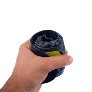 A hand holds a blue and yellow manual hand exercise tool designed for grip strength training, akin to the support arch needed in shoe insert insoles. The device is cylindrical with a grooved surface against a white background.