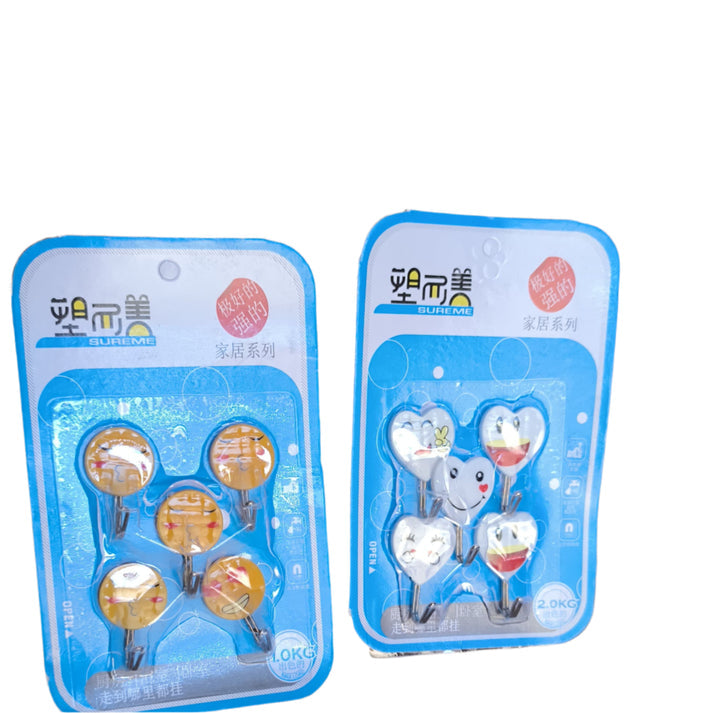 5 packs of Cartoons, self-adhesive hooks with various cartoons emoji faces are shown. Each pack contains five plastic hooks designed for easy, no-drill wall mounting. The packaging suggests they are "strong" and suitable for organizing lightweight items in homes. emoji hooks, sticky hooks, cute hooks, wall organization, self-adhesive.