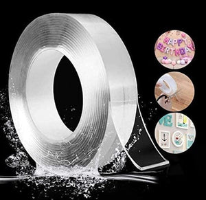 A hand applying a strip of transparent double-sided nano tape to a white wall, suggesting its use for mounting items without drilling.