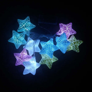 Star-shaped LED string lights used in a cozy bedroom setting, hanging on a wall or headboard, adding a romantic and dreamy ambiance - Decor