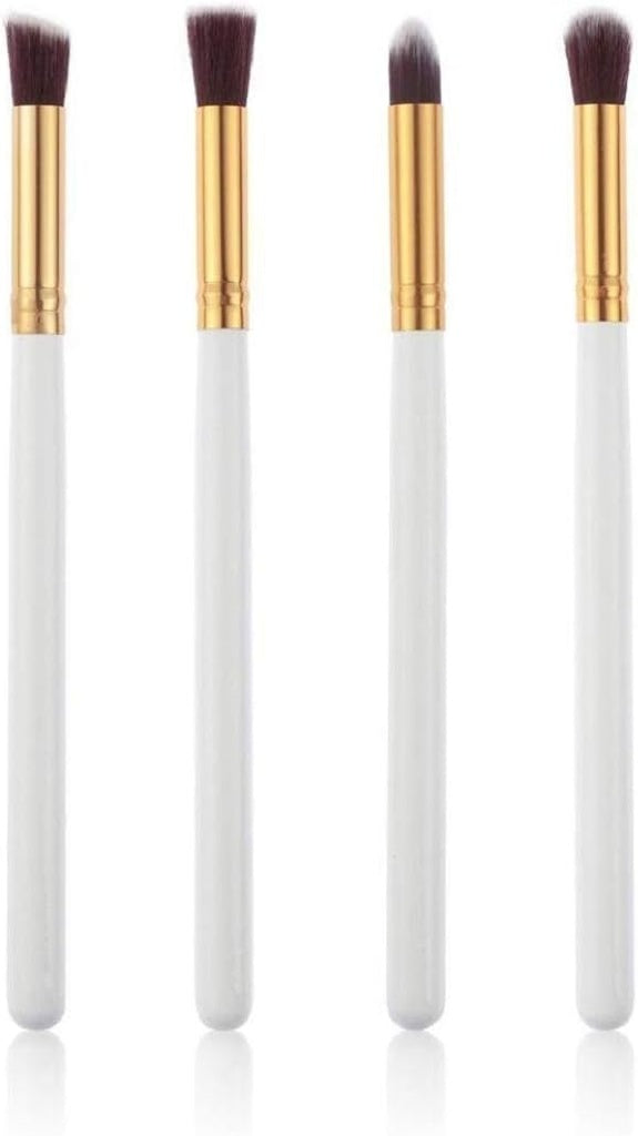 Four white/gold makeup brushes.makeup brushes, cosmetic tools.