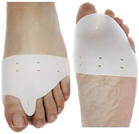  A close-up shows two bare feet, each wearing a white silicone gel toe separator that fits between the big toe and the second toe. The separators have a wider pad that extends across the ball of the foot.toe separators, toe spacer, bunion corrector, hallux valgus, foot care, orthopedic, health and personal care, silicone gel.