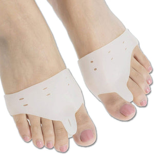 A close-up shows two bare feet, each wearing a white silicone gel toe separator that fits between the big toe and the second toe. toe separators, toe spacer, bunion corrector, hallux valgus, foot care, orthopedic, health and personal care, silicone gel.