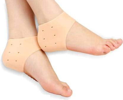 A close-up shows two bare feet, each wearing a beige silicone heel protector that covers the heel and has small ventilation holes.silicone heel protector, heel sleeve, heel cushion, foot protection, plantar fasciitis, heel pain, foot care, health and personal care.