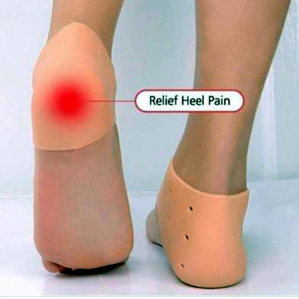 A close-up shows two bare feet, each wearing a beige silicone heel protector that covers the heel and has small ventilation holes.silicone heel protector, heel sleeve, heel cushion, foot protection, plantar fasciitis, heel pain, foot care, health and personal care.