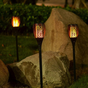 Flickering flame effect solar torch light in warm yellow for patio decor