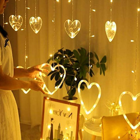 Heart-shaped curtain light with 6 big hearts and 6 small hearts for decoration hanging on a window