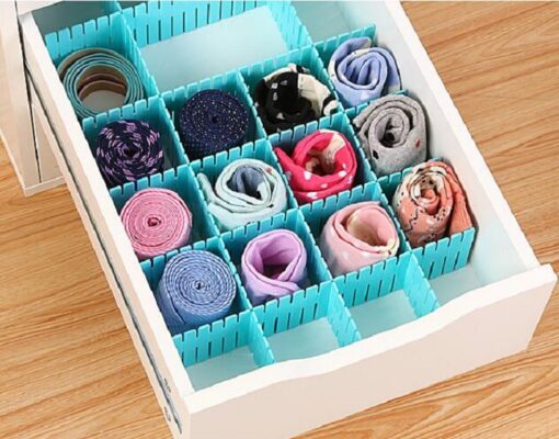 Multiple socks are organized in a drawer using adjustable blue color plastic drawer divider.