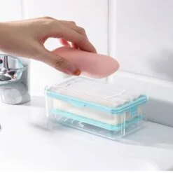 Blue color roller soap holder is shown. A woman is placing soap in the roller soap holder to use as foaming soap box.