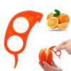 Woman is peeling off oranges using orange peeler tool.