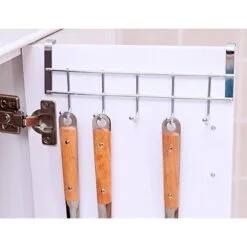 Cabinet's door is open and a stainless steel 5 cabinet hook hanger is hanged on the cabinet's door. 3 Spoons are mounted on the cabinet door hanger.