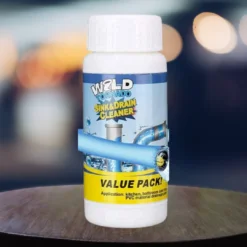 Wild tornado sink & drain cleaner bottle is placed on a wooden table in a blur background.