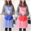 2 Girls wearing kitchen cooking apron of blue and pink colors respectively.