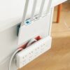 A power strip mount is mounted just below the wifi router.