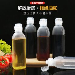 5 cooking oil plastic bottle filled with different oils are placed on a table.