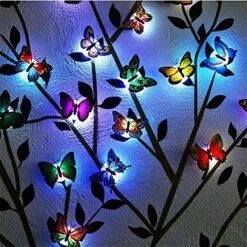 multicolor butterfly led night light presented on a wall in a dark room.