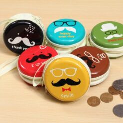 6 different earphone headphone case is placed on a desk along with few coins.