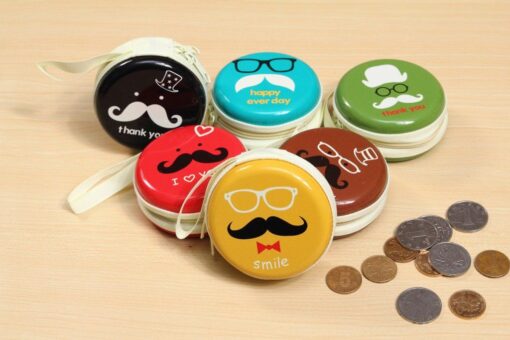 6 different earphone headphone case is placed on a desk along with few coins.