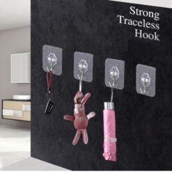 4 sticky hanging hooks are sticked on wall.