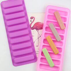 Front and back side of silicone ice cube tray for water bottles along with 4 ice cube of different colors.