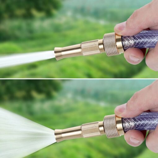 A man is using high pressure water hose nozzle to water the garden.