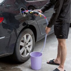 A guy is transferring oil in the black car from the bucket using Oil Transfer Pump Kit.