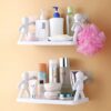 2 plastic wall mounted shower caddy mounted on bathroom wall and several bottles and soaps are kept on it.