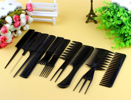 Styling comb set consisting of 10 different black color combs are placed on a table next to flowers.