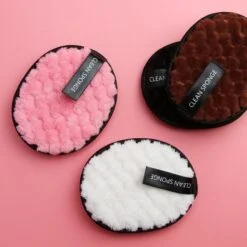 Round makeup remover pads are presented in pink, white, black, and brown color.