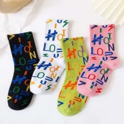 Black, white, green, and pink color letter printed socks.