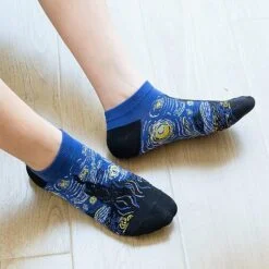 Black and blue ankle length cotton socks is being worn by a guy