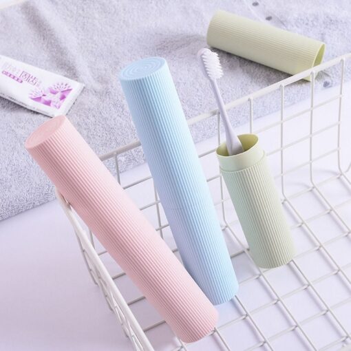 Plastic toothbrush case is presented in pink, blue, and cream color in a steel vessel.