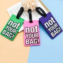 3 funny luggage tags of green, pink, and blue color