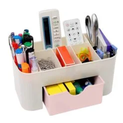 Plastic desk organizer is filled with all stationaries like markers, remotes, stapler, pens, etc.