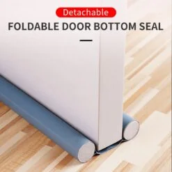 Grey color double sided door stopper strip is placed under the door.