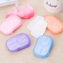 Portable hand soap sheets with different color cases are kept on a table.
