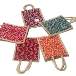 5 different color floral jute bag are being placed in a circle