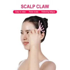 Pink color scalp massager tool is being used by a girl on her scalp.